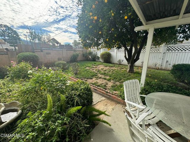 a view of a chairs and table in backyard