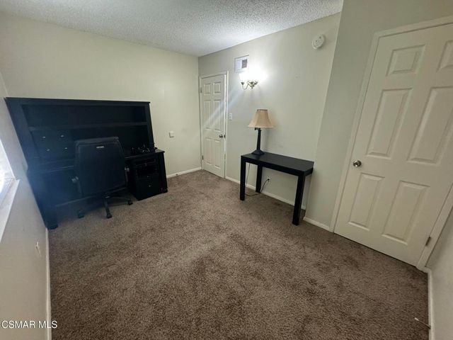 a view of a livingroom with furniture and a window