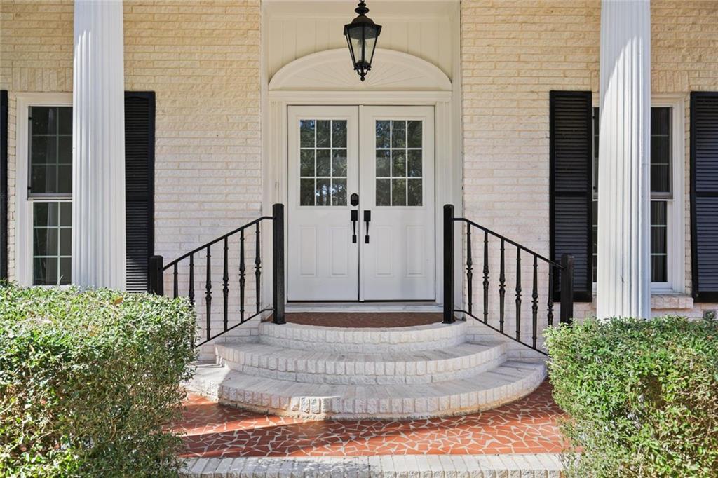 4505 Cochran Mill Road Fairburn, GA 30213 - Photo 3 of 36 a view of a porch with a floor to ceiling window and stairs