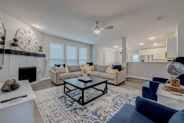 a living room with furniture and a fireplace