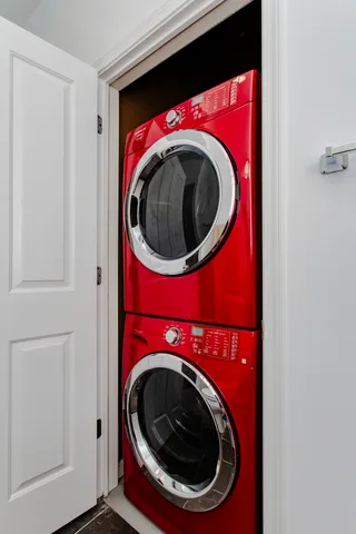 a view of a hallway with wooden floor and closet