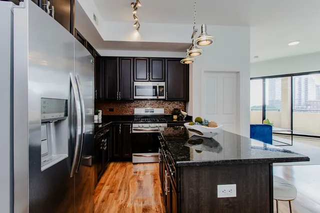 a kitchen with a sink stainless steel appliances and cabinets