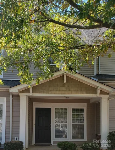 an empty room with windows and ceiling fan