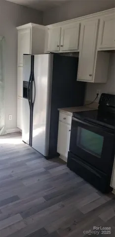 a view of wooden floor and windows in a room