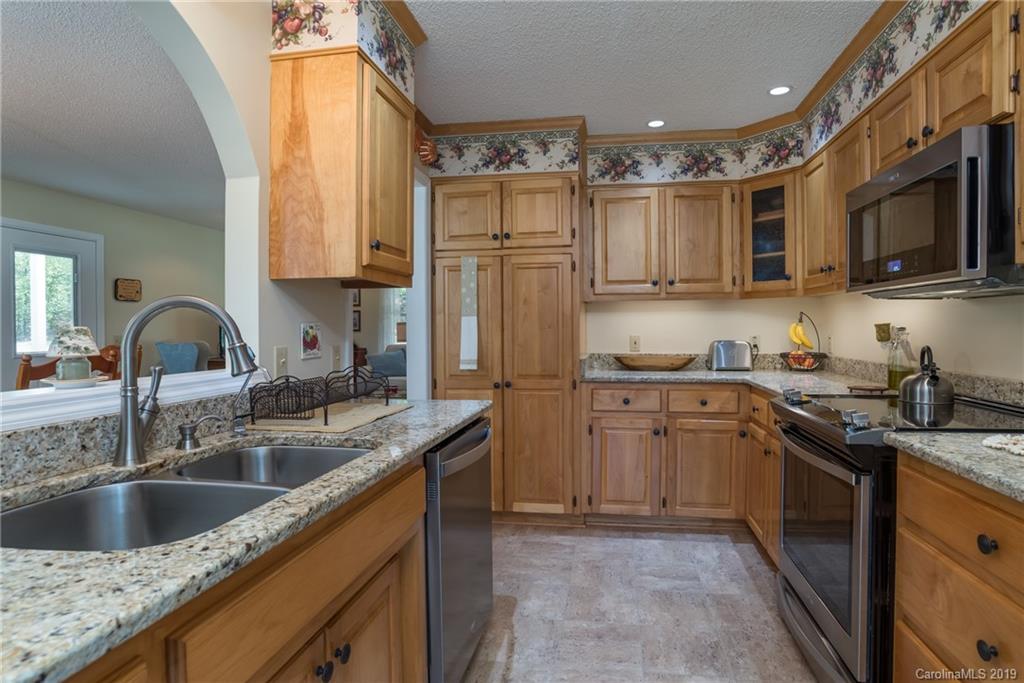 433 Meadow Crest Road Tryon, NC 28782 - Photo 13 of 29 a kitchen with stainless steel appliances granite countertop a sink stove and refrigerator