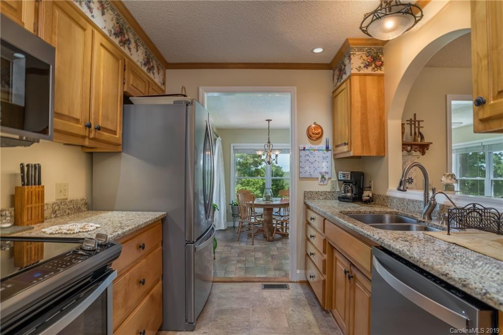433 Meadow Crest Road Tryon, NC 28782 - Photo 14 of 29 a kitchen with stainless steel appliances granite countertop a sink stove and refrigerator