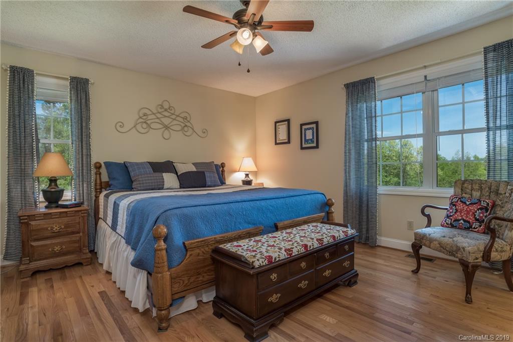 433 Meadow Crest Road Tryon, NC 28782 - Photo 18 of 29 a bedroom with a bed and wooden floor
