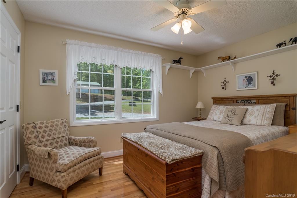 433 Meadow Crest Road Tryon, NC 28782 - Photo 20 of 29 a bedroom with a bed and a couch
