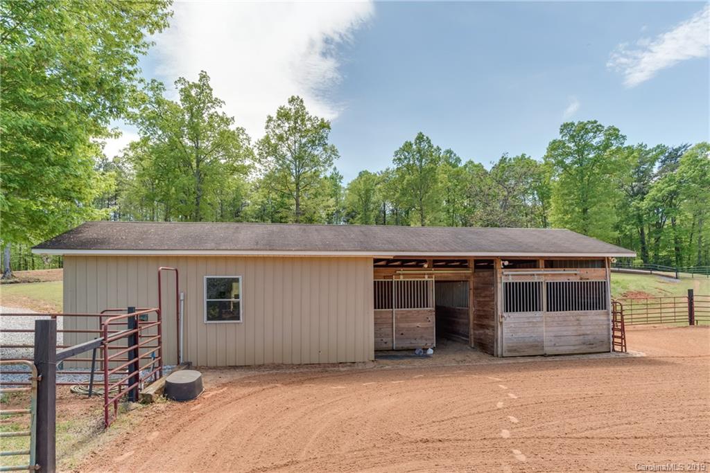 433 Meadow Crest Road Tryon, NC 28782 - Photo 7 of 29 a front view of a house with a garden