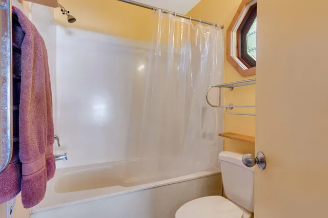 a bathroom with a shower curtain and a window
