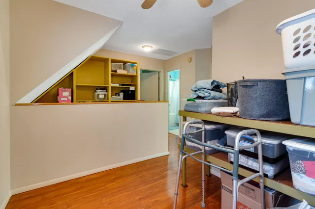 a view of kitchen with stainless steel appliances cabinets and wooden floor