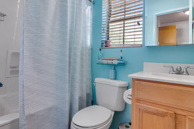 a white toilet sitting next to a bathroom sink