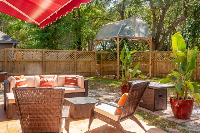 a view of a patio with table and chairs potted plants