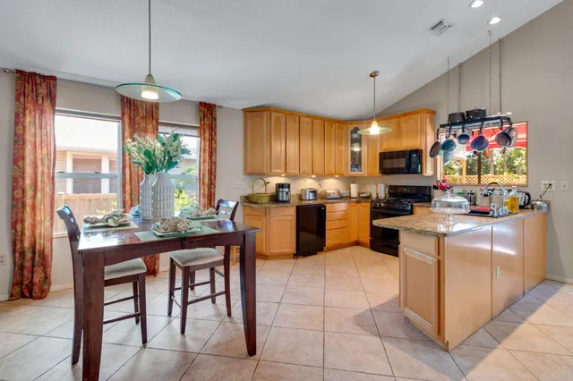 a kitchen with microwave a stove and cabinets