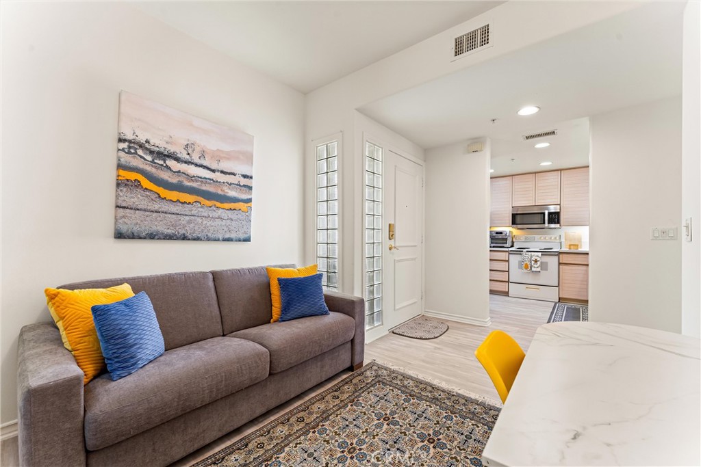 2243 Martin, Unit 415 Irvine, CA 92612 - Photo 15 of 34 a living room with furniture and a flat screen tv