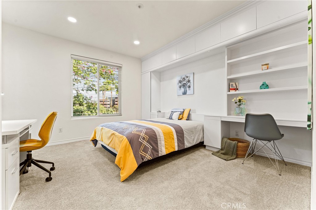 2243 Martin, Unit 415 Irvine, CA 92612 - Photo 16 of 34 a bedroom with a bed chair and window