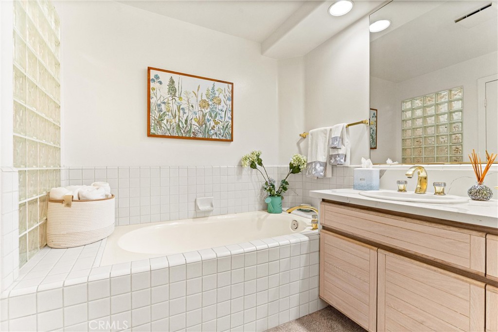 2243 Martin, Unit 415 Irvine, CA 92612 - Photo 18 of 34 a spacious bathroom with sink and mirror