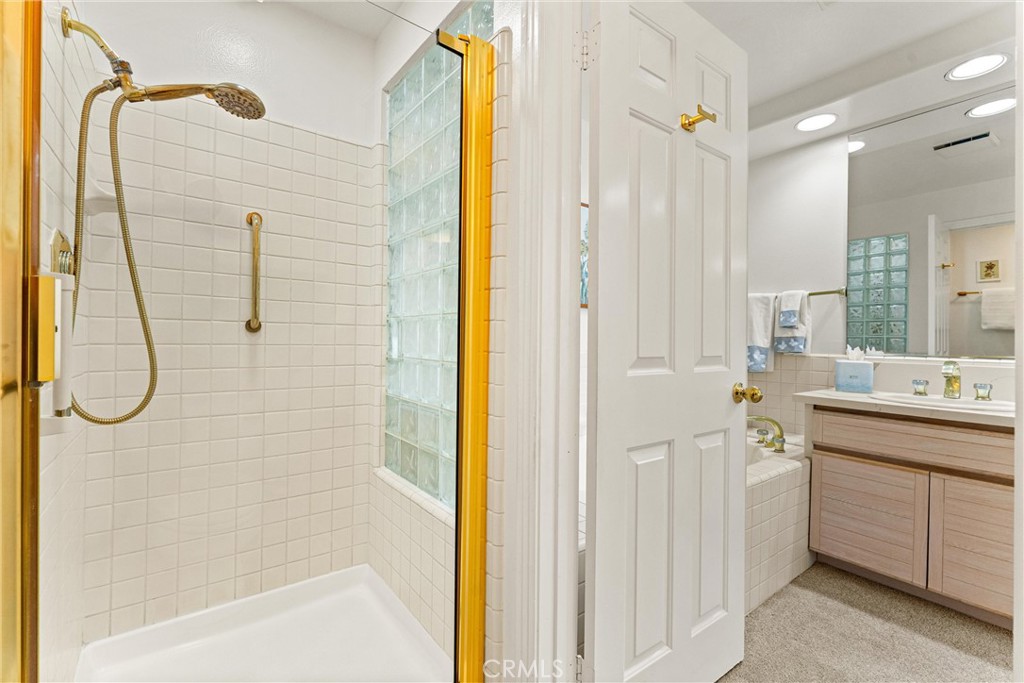 2243 Martin, Unit 415 Irvine, CA 92612 - Photo 19 of 34 a bathroom with a shower sink and mirror