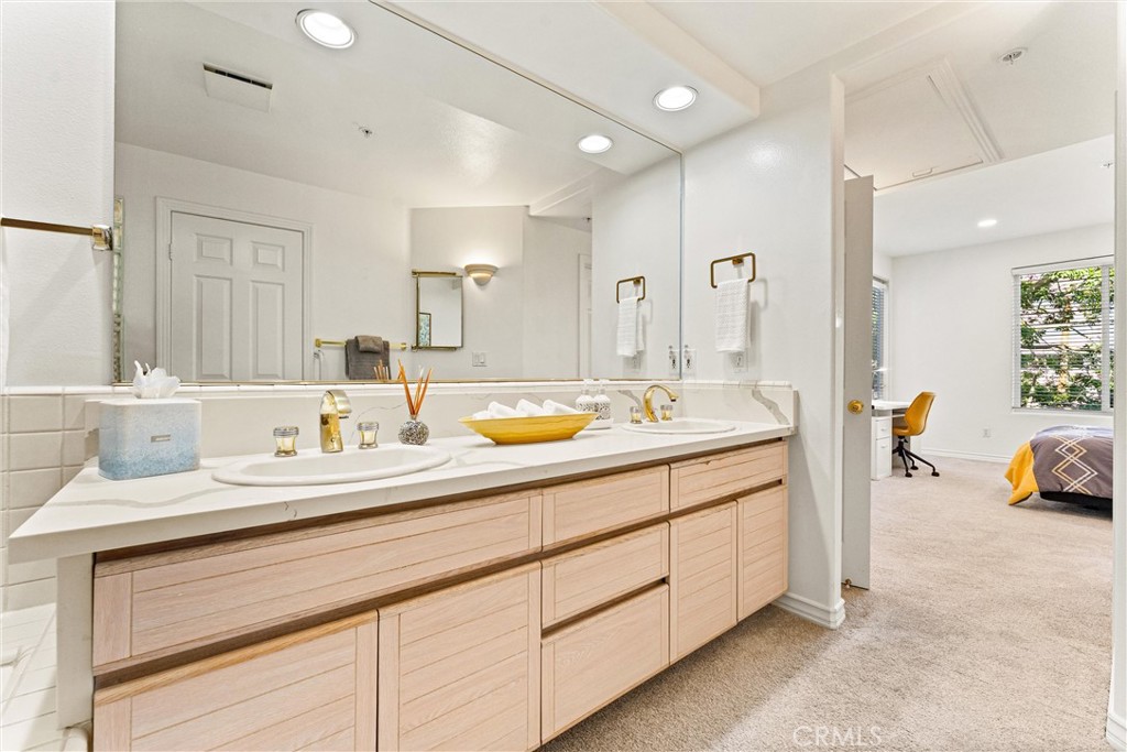 2243 Martin, Unit 415 Irvine, CA 92612 - Photo 20 of 34 a bathroom with a sink double vanity and a mirror