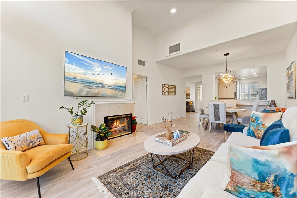 2243 Martin, Unit 415 Irvine, CA 92612 - Photo 2 of 34 a living room with furniture and a fireplace