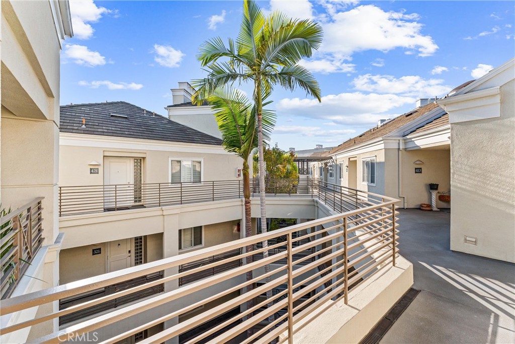 2243 Martin, Unit 415 Irvine, CA 92612 - Photo 28 of 34 a view of a balcony with a potted plant and sign on the wall