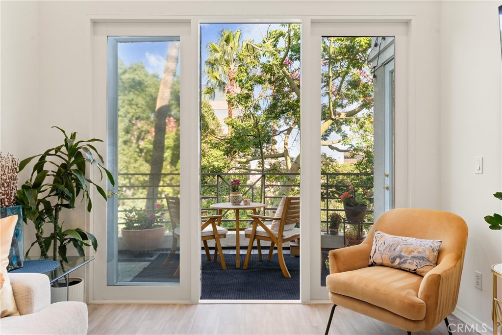 2243 Martin, Unit 415 Irvine, CA 92612 - Photo 4 of 34 a living room with furniture and a floor to ceiling window