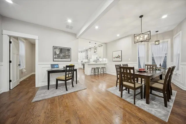 a view of a a dining room with furniture window and wooden floor