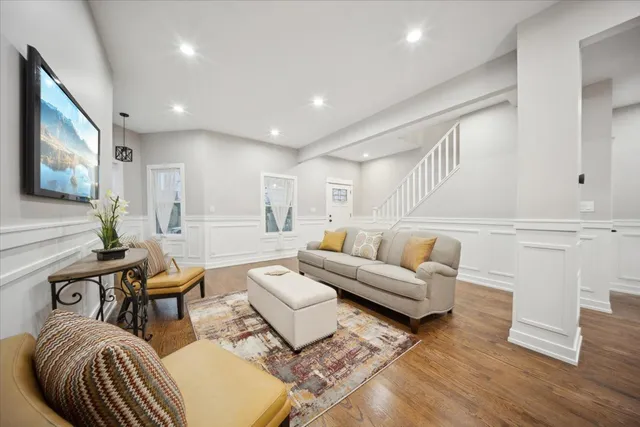 a living room with furniture and wooden floor
