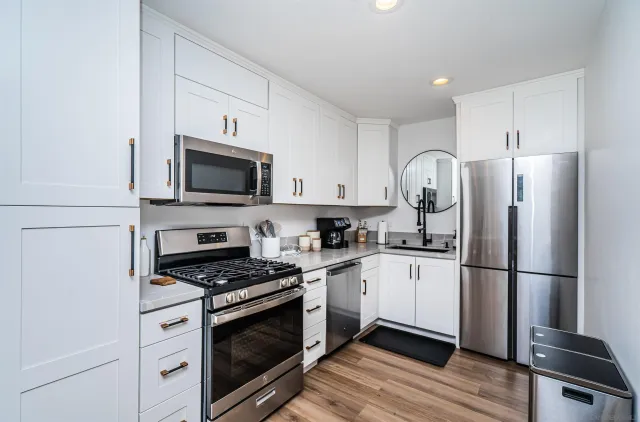a kitchen with stainless steel appliances a refrigerator stove and microwave