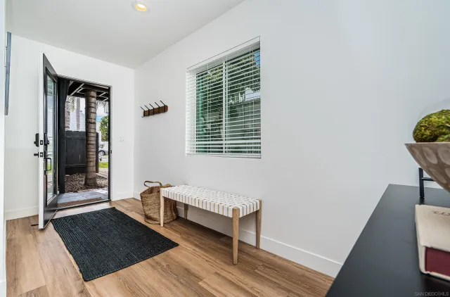 a view of a dining room with furniture and mirror