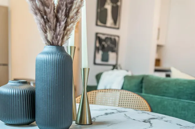 a living room with furniture a flat screen tv and kitchen view