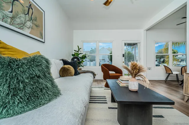 a living room with furniture and wooden floor