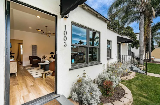 a kitchen with stainless steel appliances a dining table chairs and couches