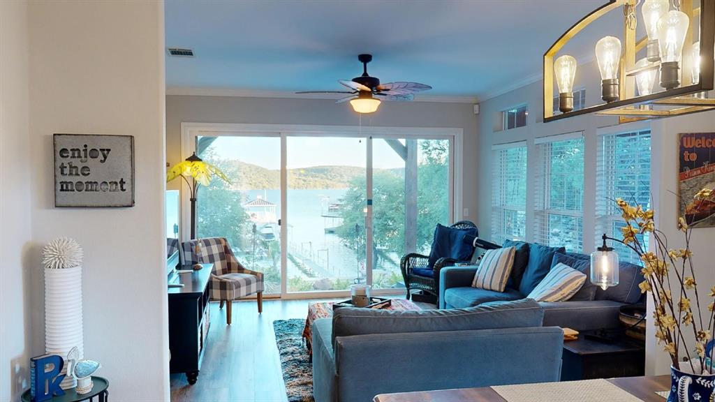 4925 Butler Lane Graham, TX 76450 - Photo 13 of 36 a living room with furniture a flat screen tv and a floor to ceiling window