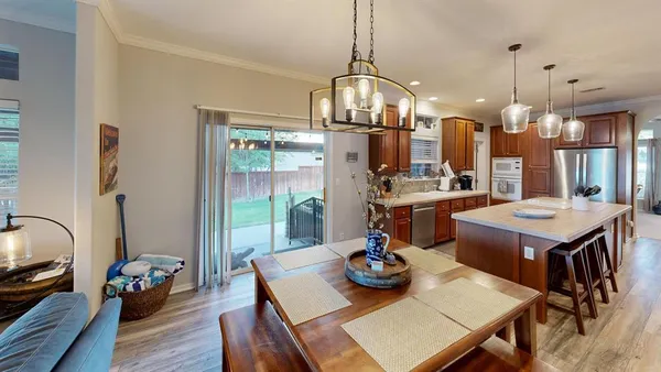 a kitchen with stainless steel appliances granite countertop a refrigerator and a stove