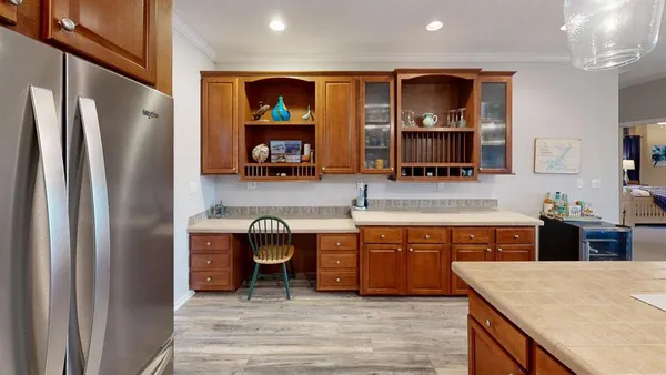 a large kitchen with stainless steel appliances granite countertop a stove and refrigerator