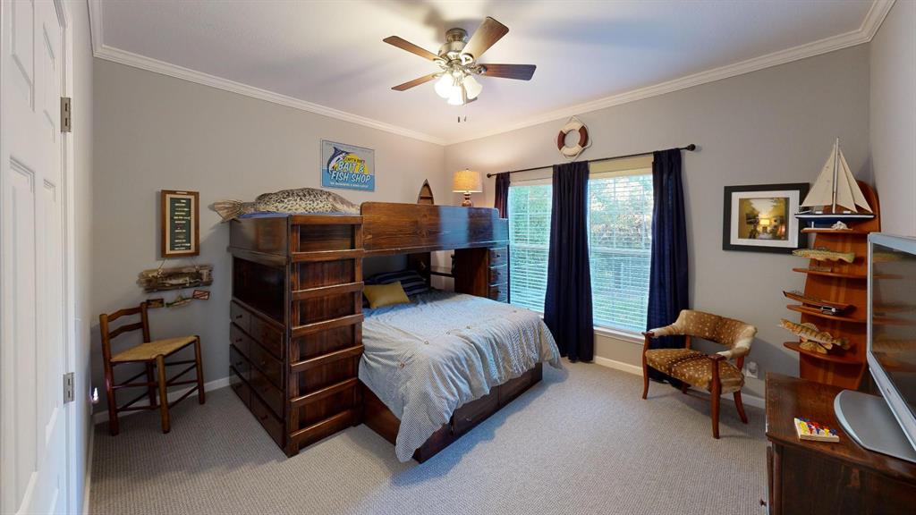 4925 Butler Lane Graham, TX 76450 - Photo 25 of 36 a bedroom with a bed and a chandelier