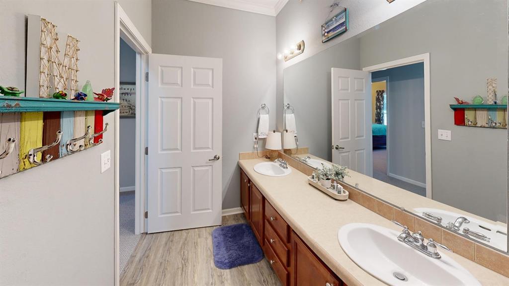 4925 Butler Lane Graham, TX 76450 - Photo 26 of 36 a bathroom with a sink double vanity and a mirror