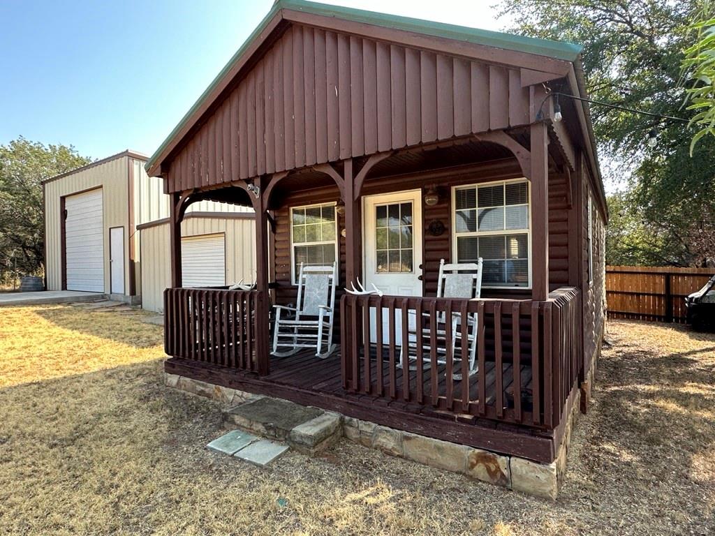 4925 Butler Lane Graham, TX 76450 - Photo 31 of 36 a view of a wooden house with a small yard and large trees
