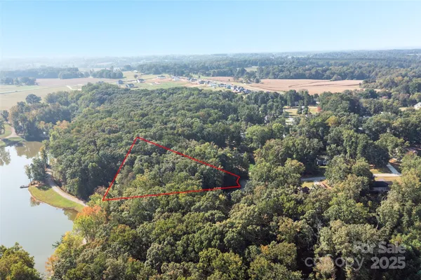 an aerial view of residential house with outdoor space and trees around