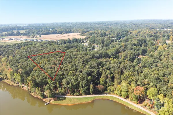 an aerial view of house with yard and ocean view