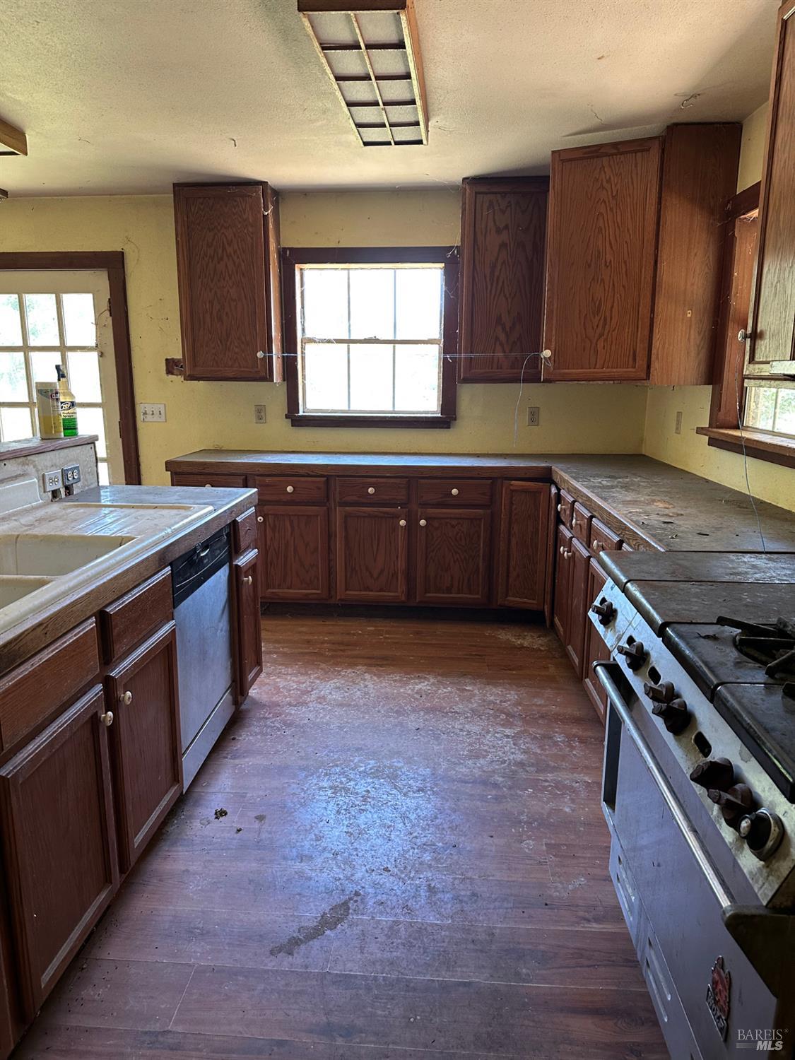 13333 Low Gap Road Ukiah, CA 95482 - Photo 29 of 50 a kitchen with stainless steel appliances granite countertop a stove a sink and a microwave