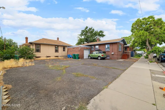 a city street lined with buildings and trees