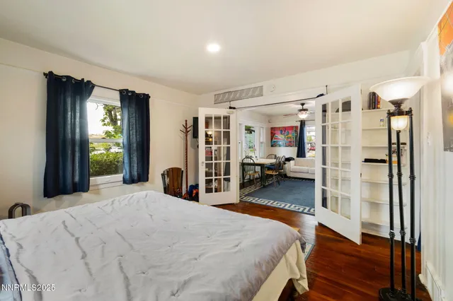 a bedroom with a large bed and a large window