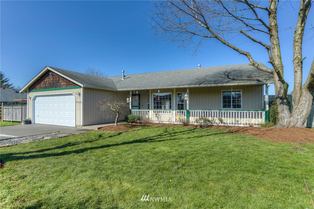 9320 181st Way Southwest Rochester, WA 98579 - Photo 1 of 21 a front view of a house with a garden and yard