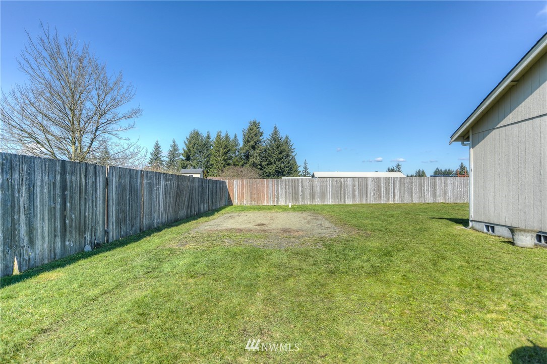 9320 181st Way Southwest Rochester, WA 98579 - Photo 20 of 21 a view of a backyard with wooden fence