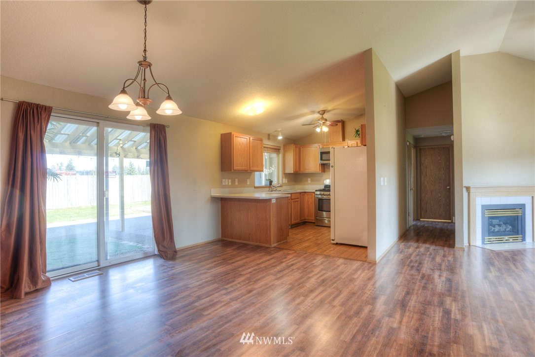 9320 181st Way Southwest Rochester, WA 98579 - Photo 6 of 21 a view of a kitchen and a chandelier fan
