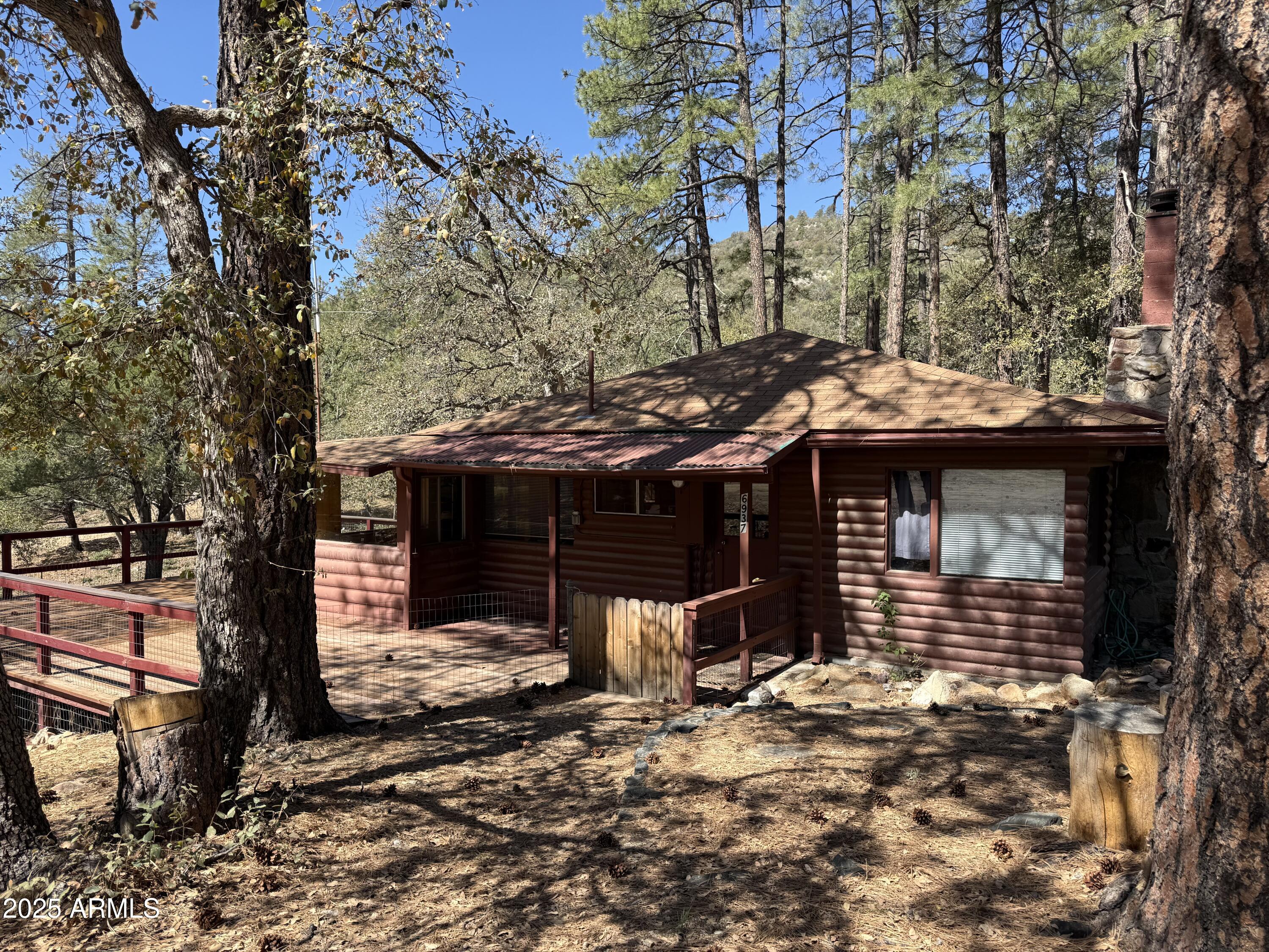 a view of a house with a yard covered in snow