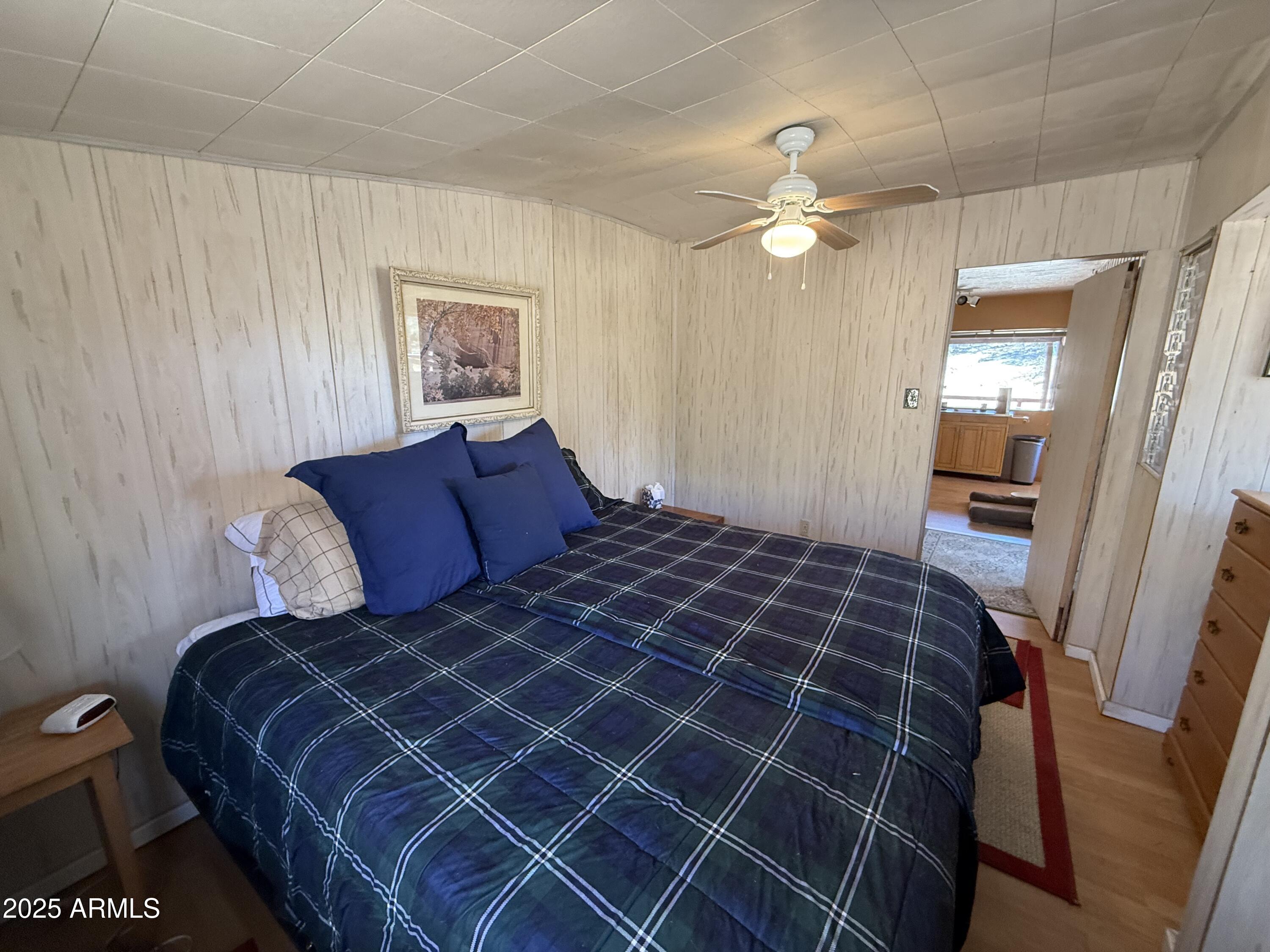 6937 Torpedo Road Crown King, AZ 86343 - Photo 18 of 23 a bedroom with a bed and a chandelier