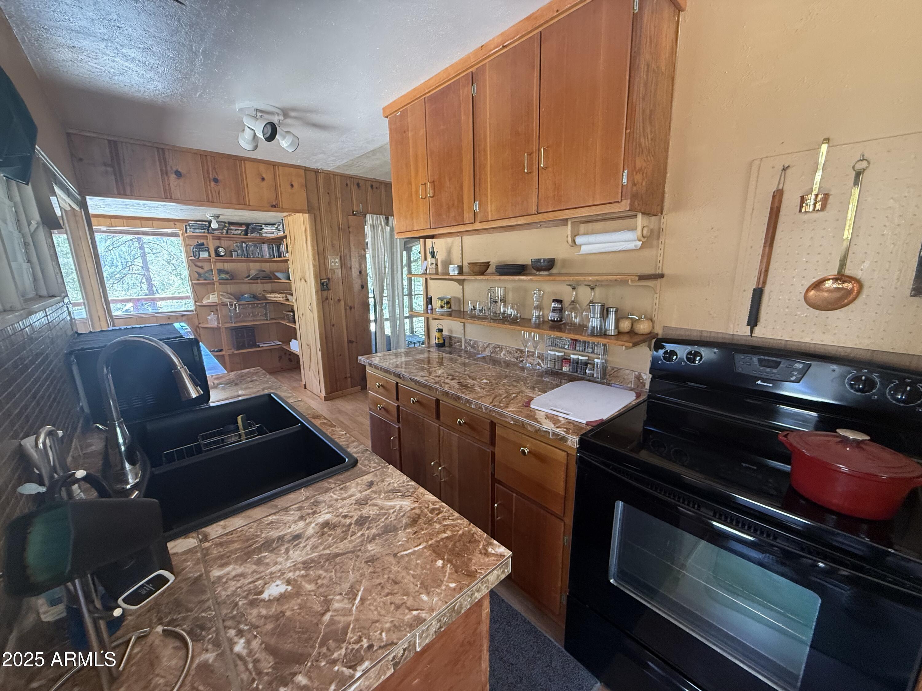 6937 Torpedo Road Crown King, AZ 86343 - Photo 2 of 23 a kitchen with a stove a sink and a microwave